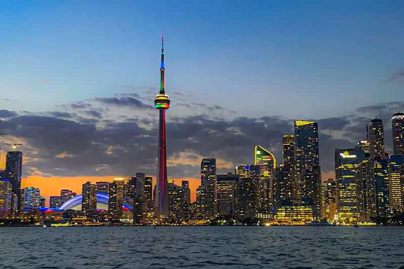 Toronto skyline at dusk across Lake Ontario